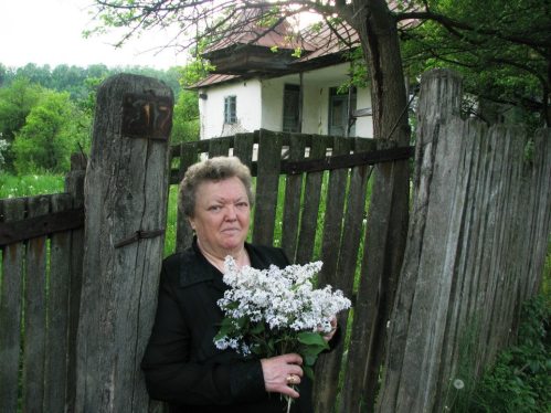 My mom in front of childhood house village Easter 2013
